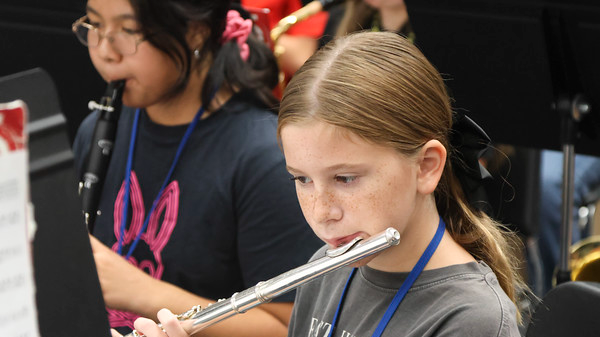 two students, one playing clarinet the other playing the flute