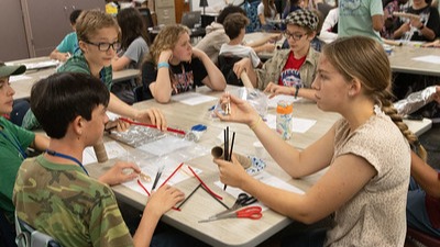 six students sitting around a table working