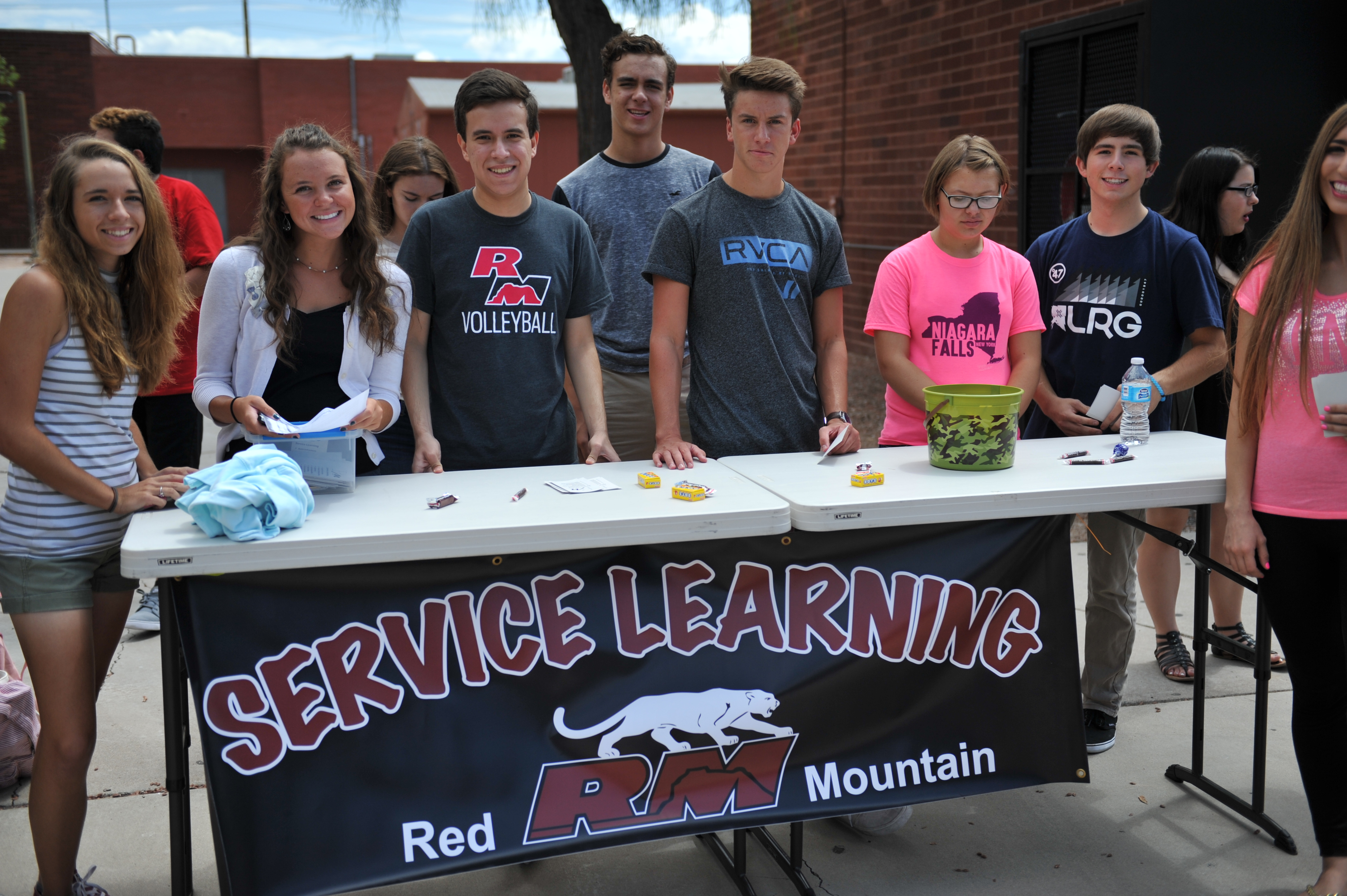 RMHS Service Learning, 8 students standing at table
