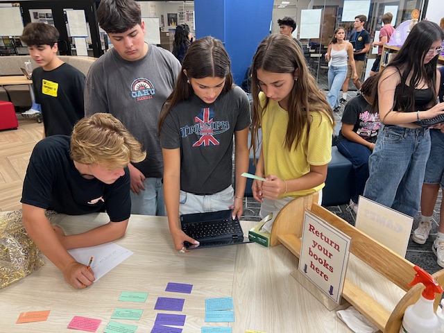 Students working to solve a clue