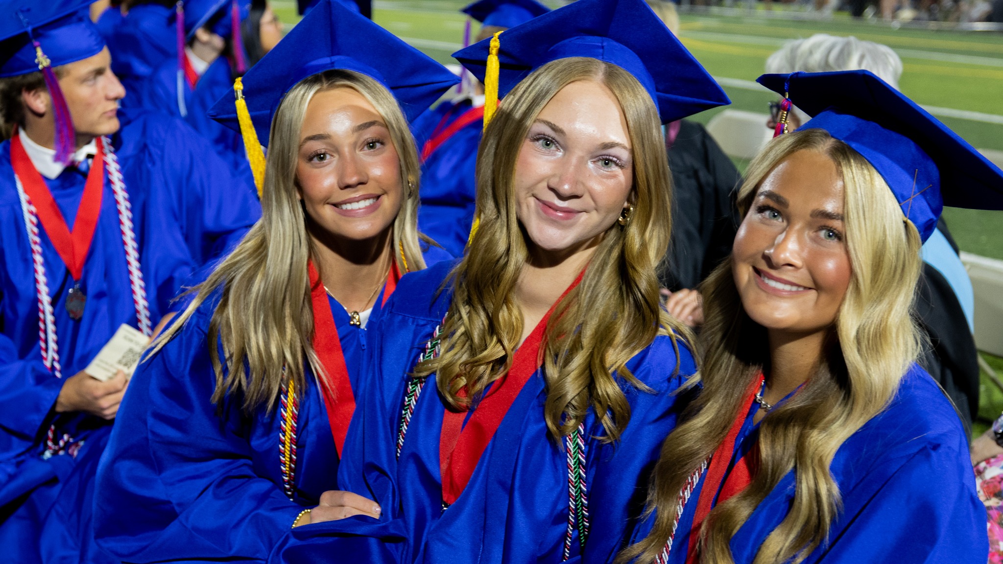 three girs sitting at Mountain View HS graduation