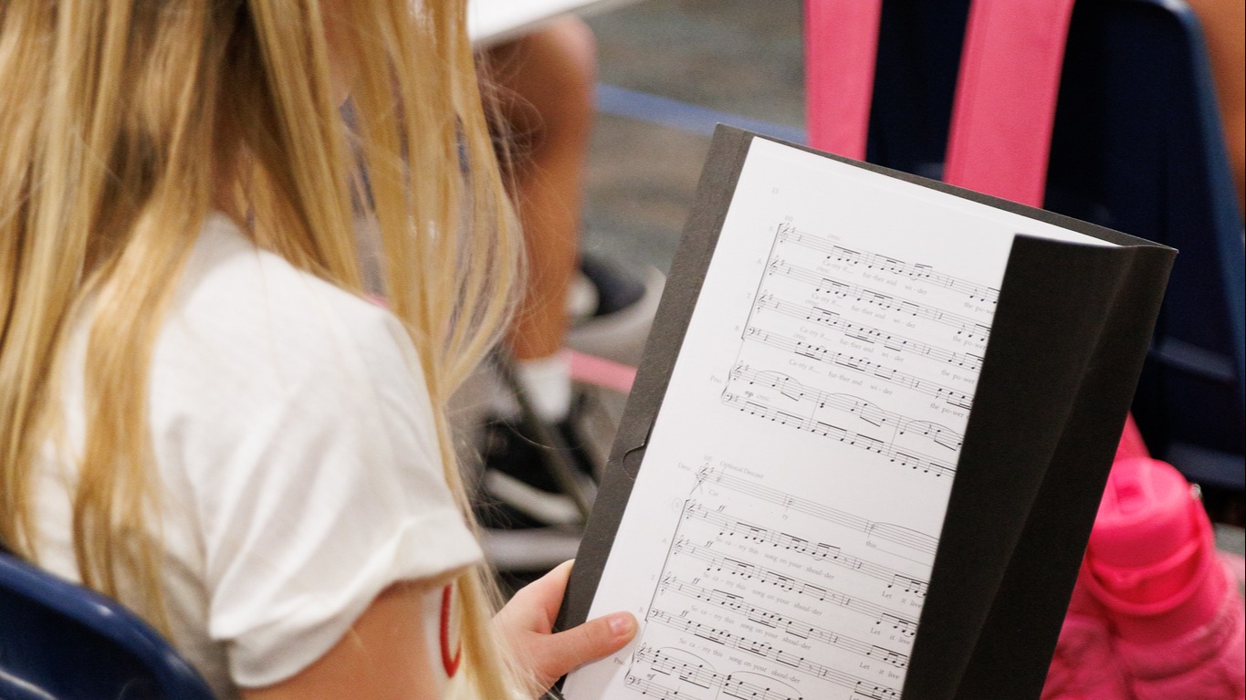 student looking at choir book