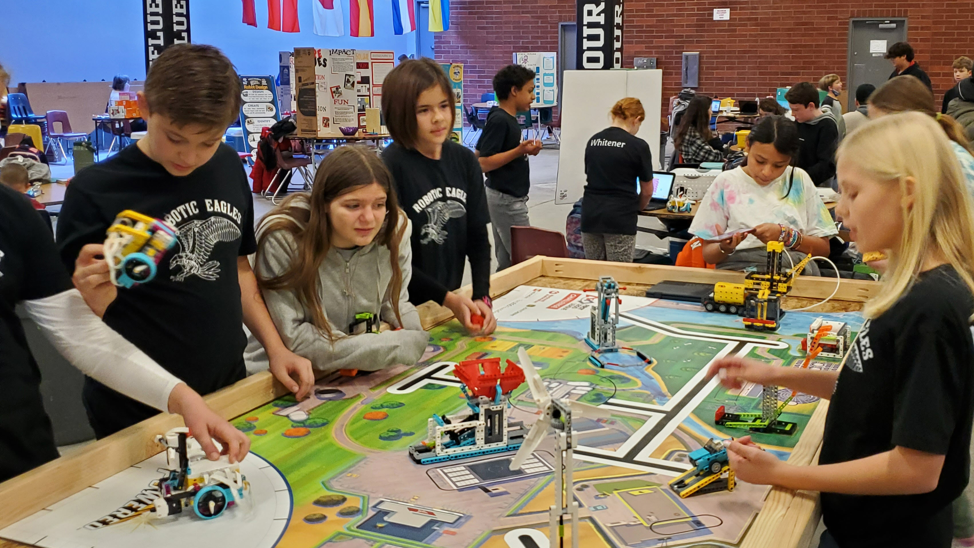 students working around a  sim town table