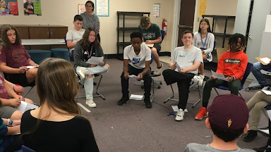 Students sitting in chairs in a circle