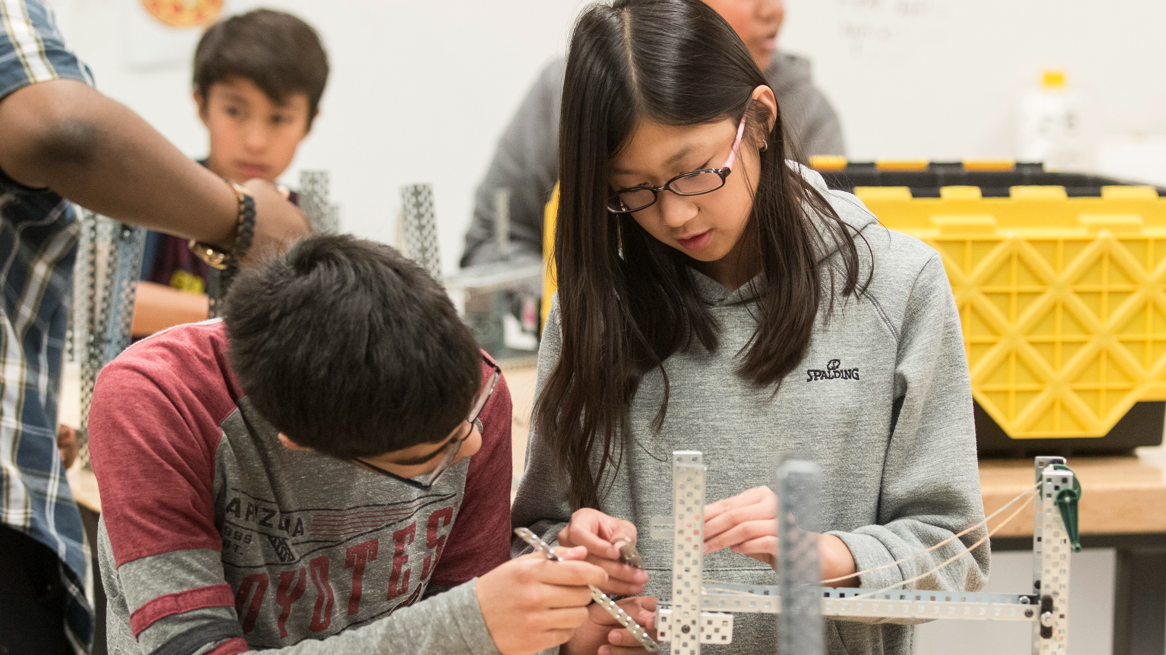 two students building something
