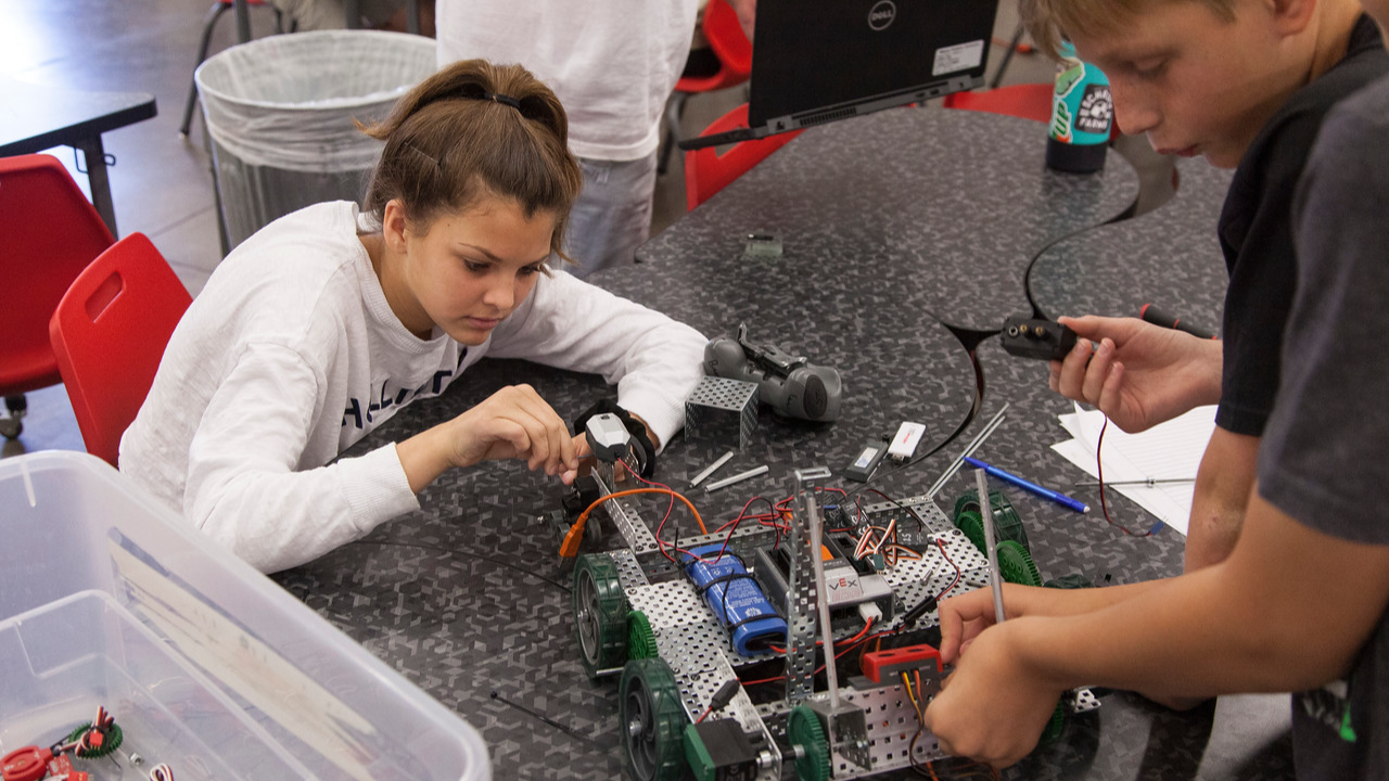 two students working with a robot