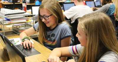 two girls using a computer