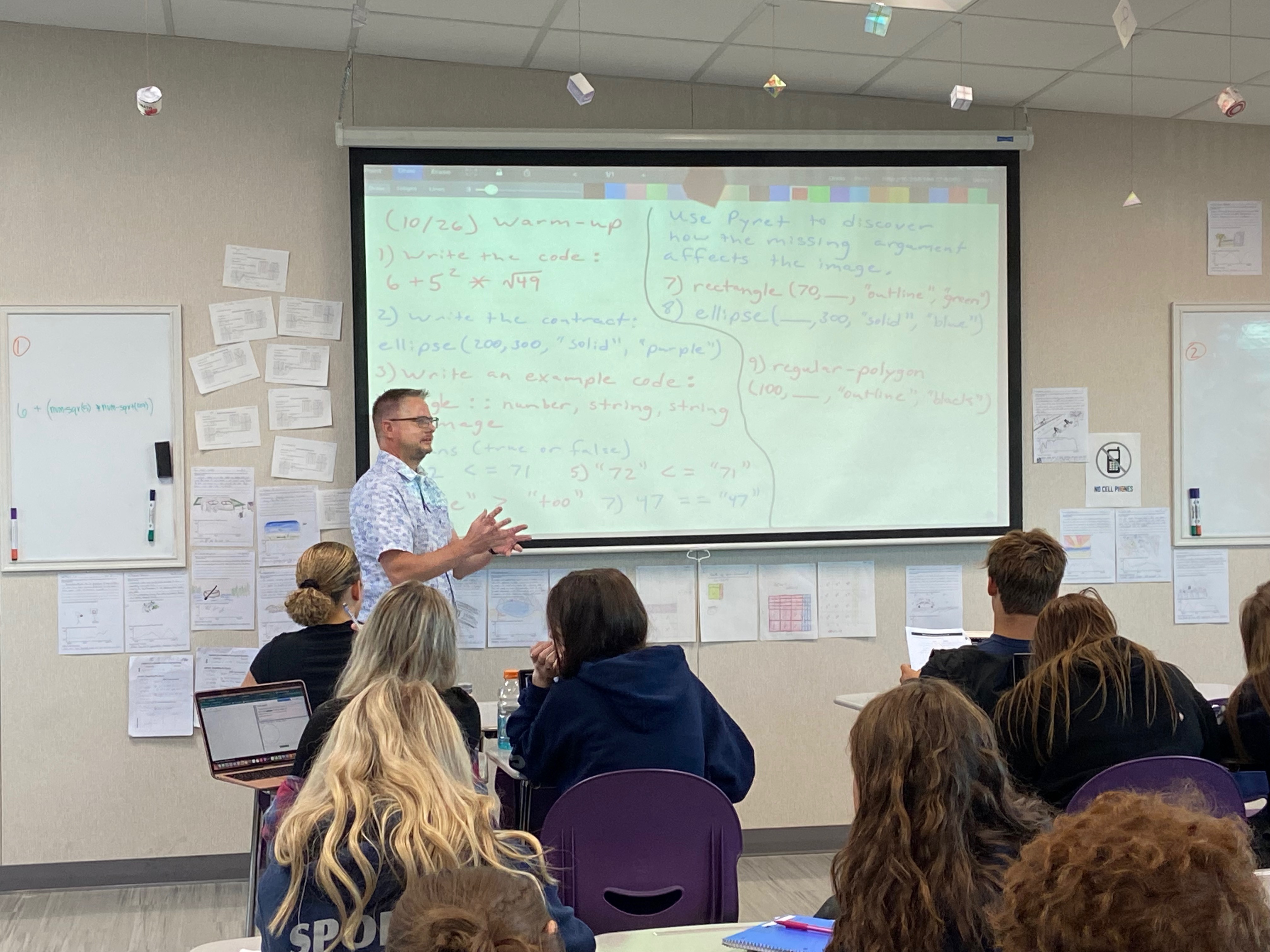 Teacher teaching bootstrap algebra with students