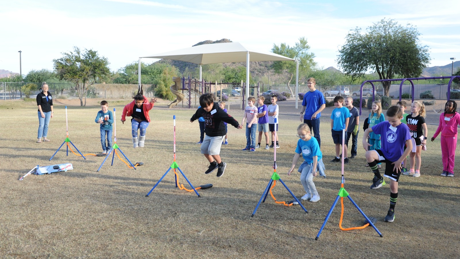 students on the playground launching rockets