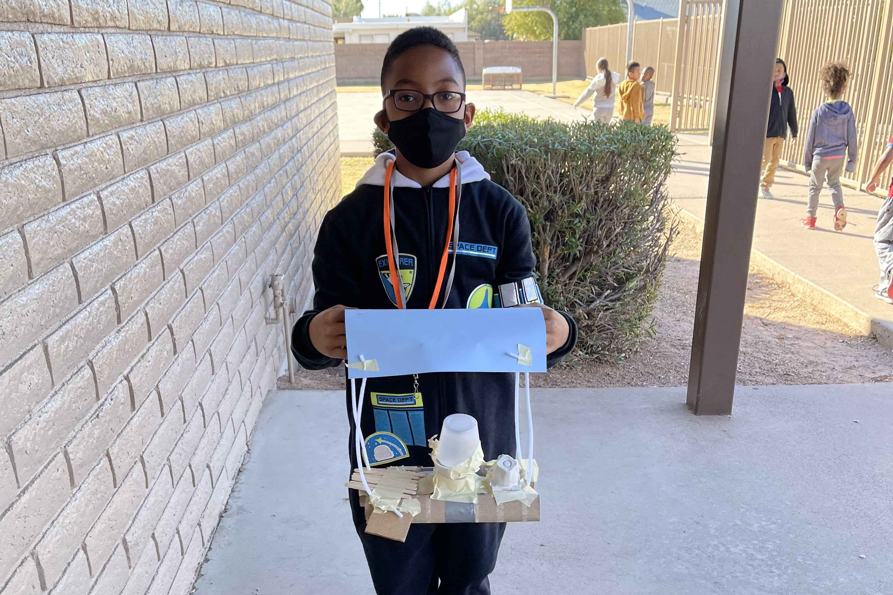 Student holding his STEM project