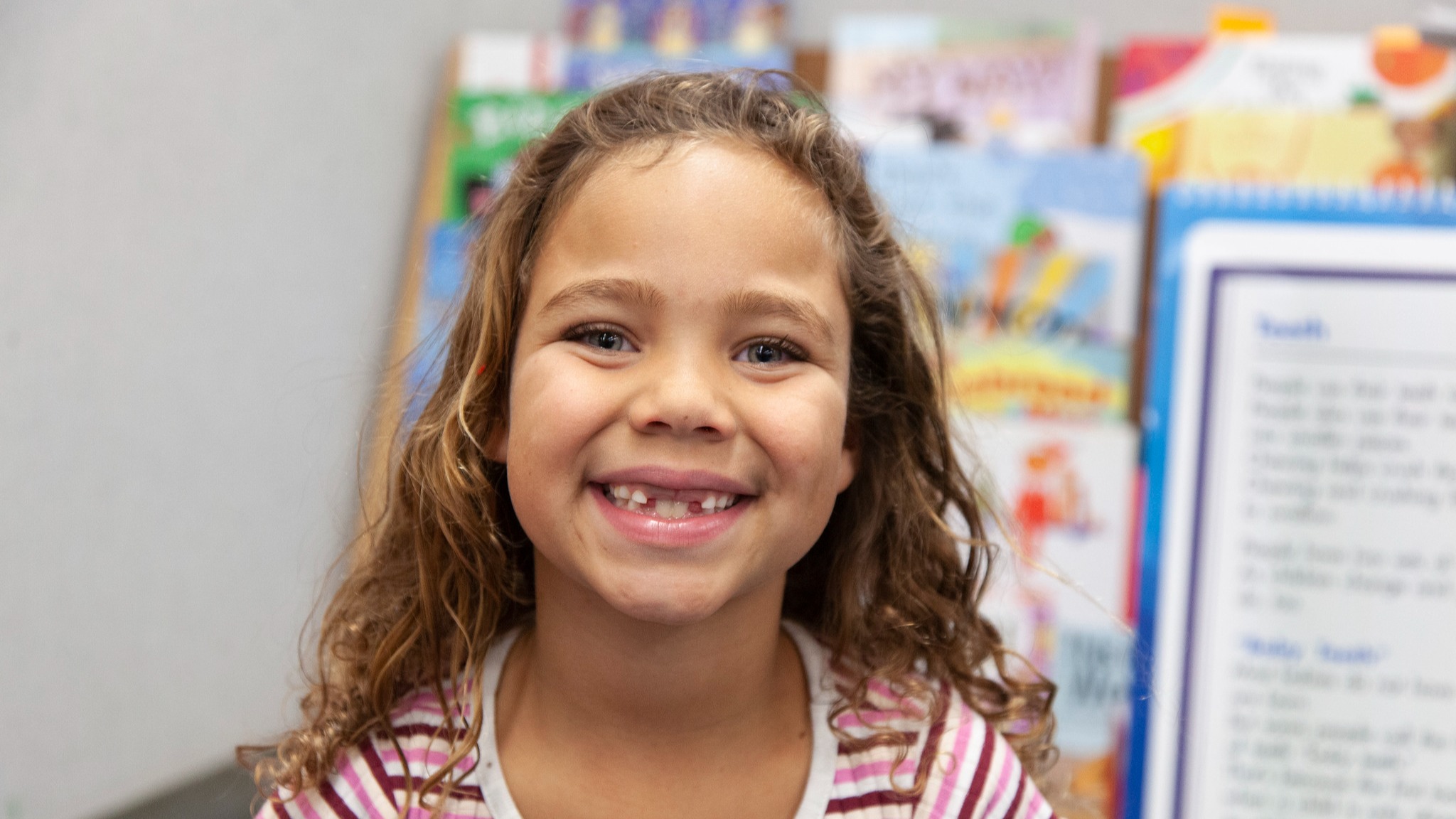 student smiling in a classroom