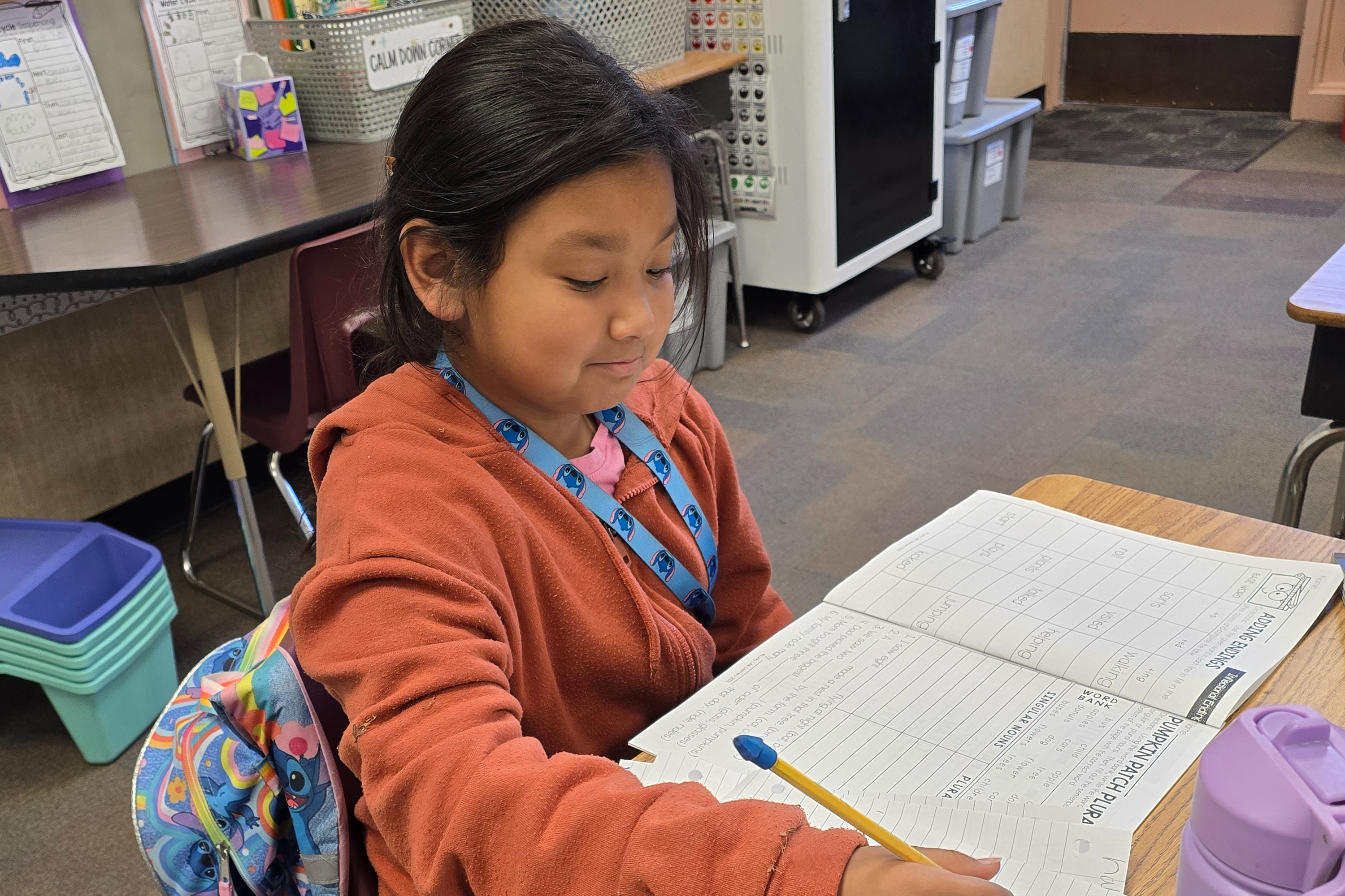 A second grade student working on a writing assignment.