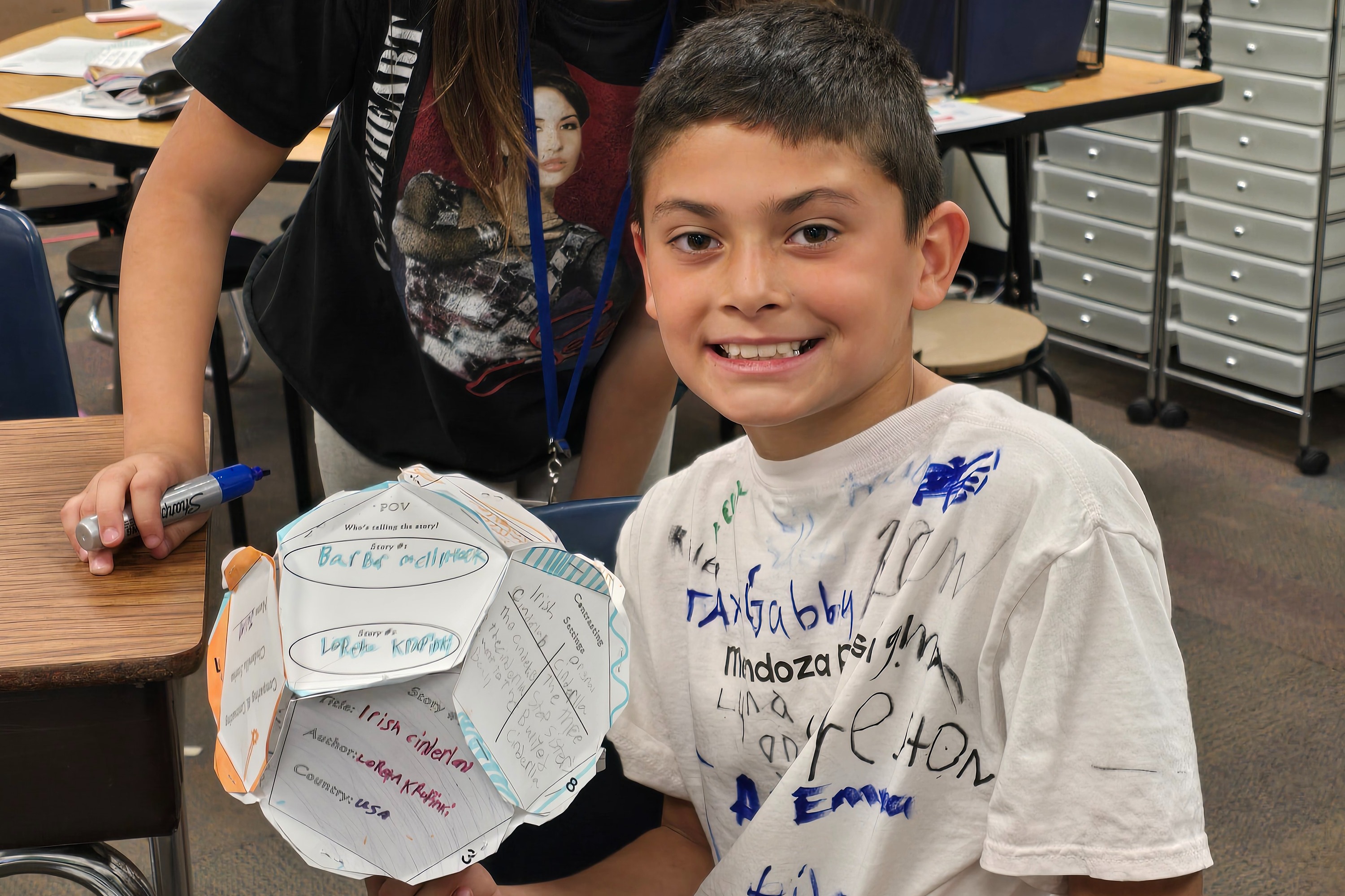 A fourth-grade students showing off a project.