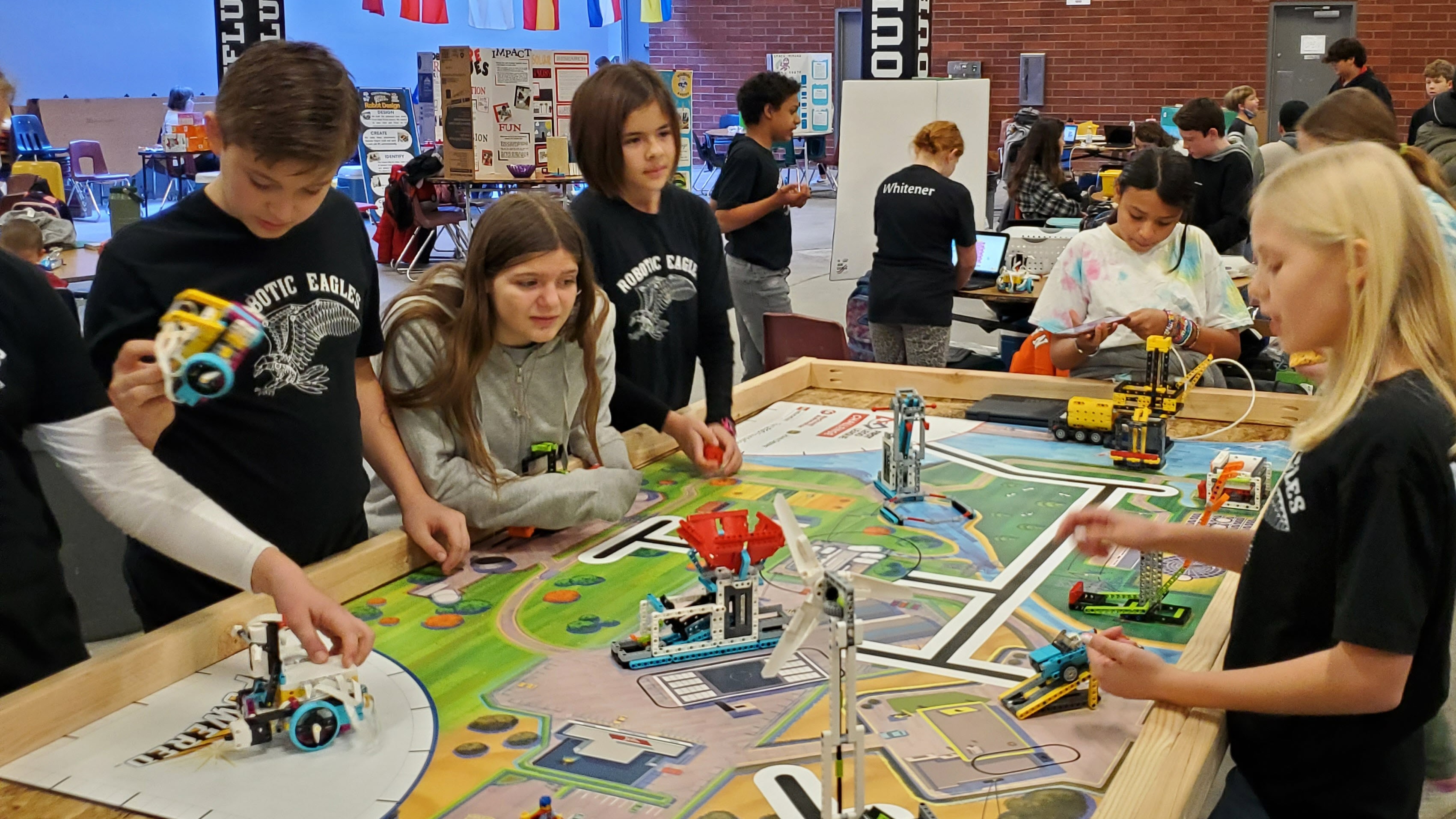 students working around a  sim town table