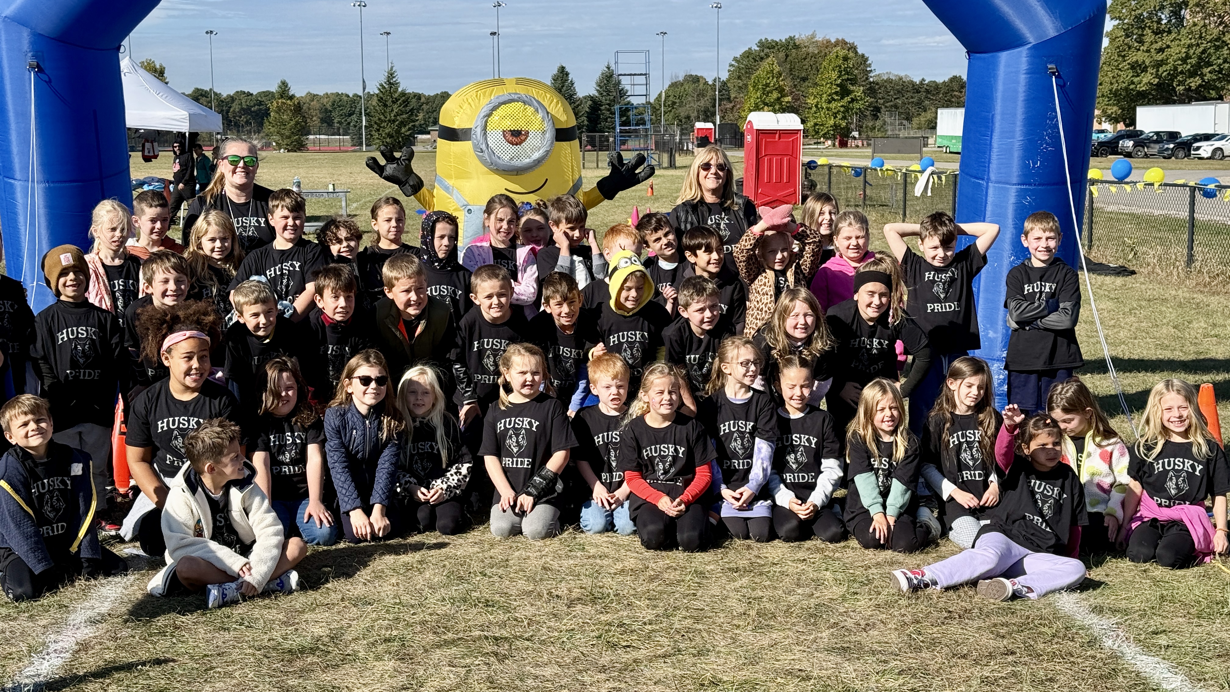 Group of students posing for photo outside fun run