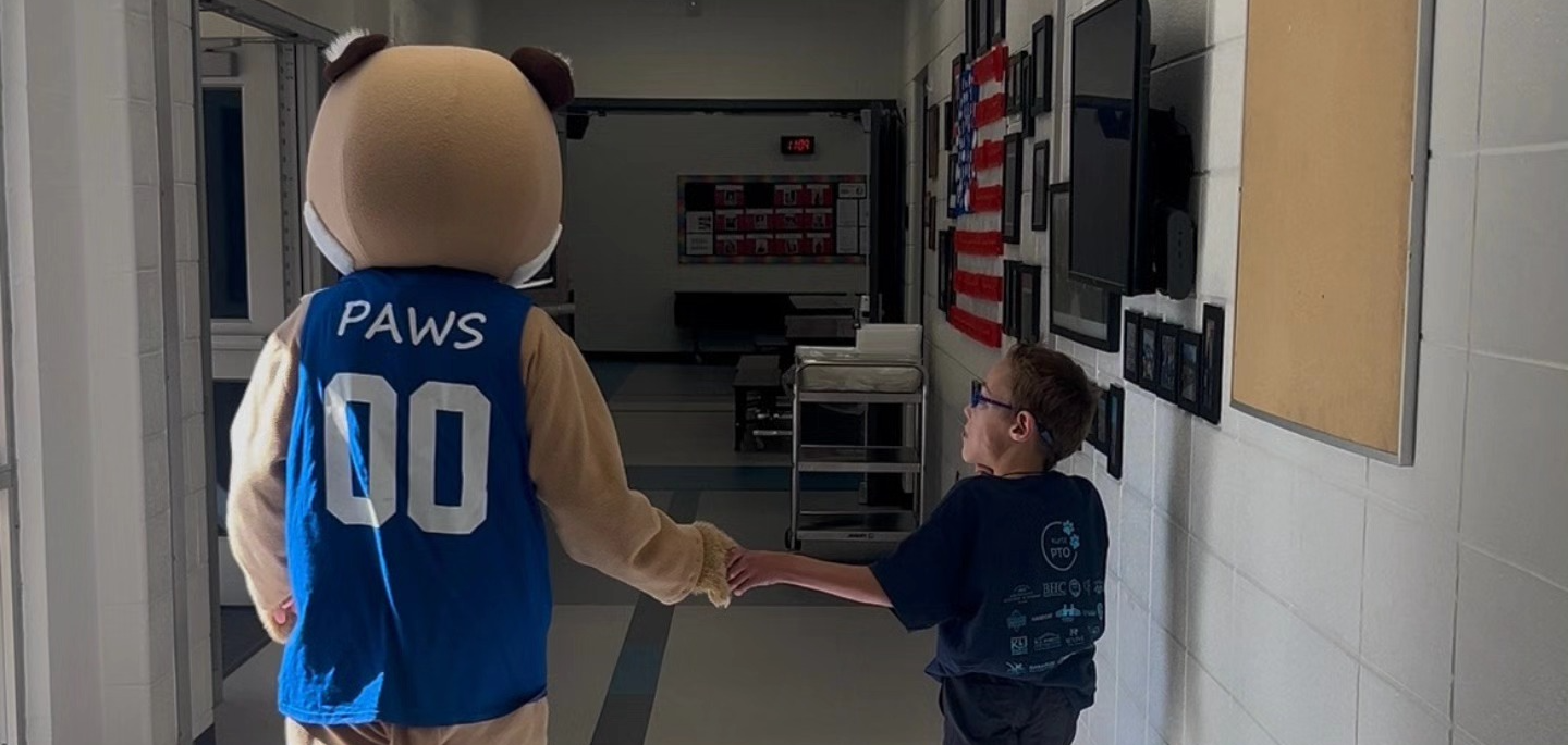 Paws holding hands with a Kurtz kid