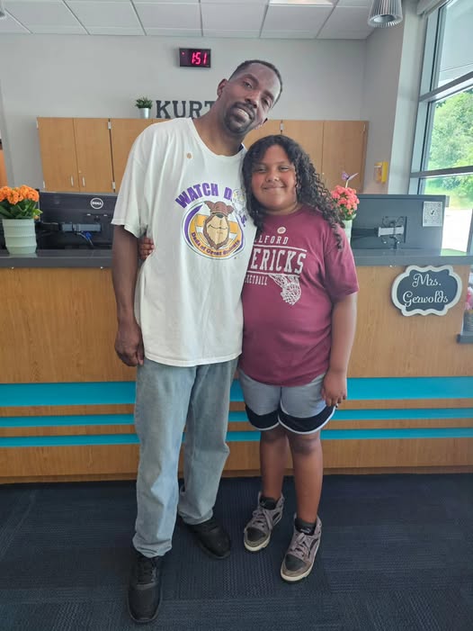 Adult posing with student in school office for the watch d.o.g.s. program