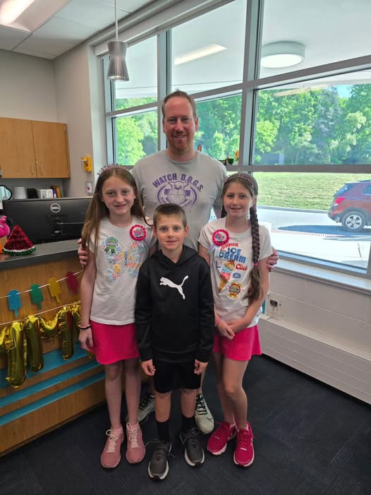 Adult posing with student in school office for the watch d.o.g.s. program
