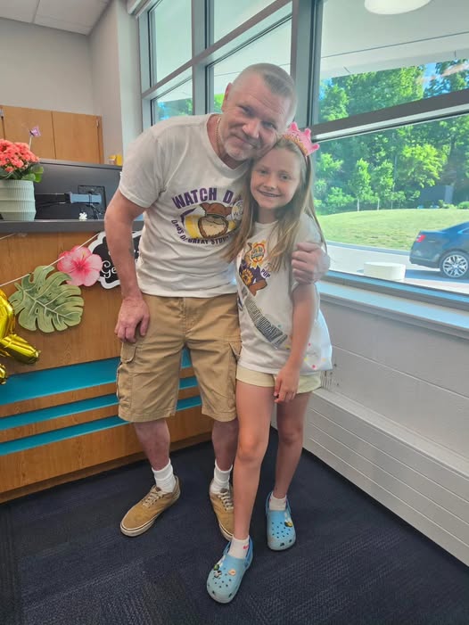 Adult posing with student in school office for the watch d.o.g.s. program