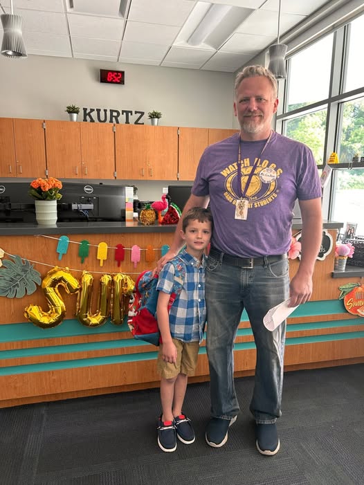 Adult posing with student in school office for the watch d.o.g.s. program