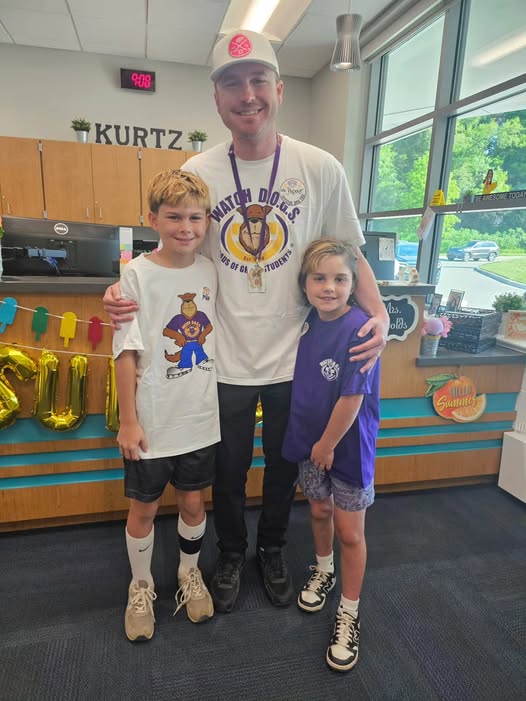 Adult posing with student in school office for the watch d.o.g.s. program