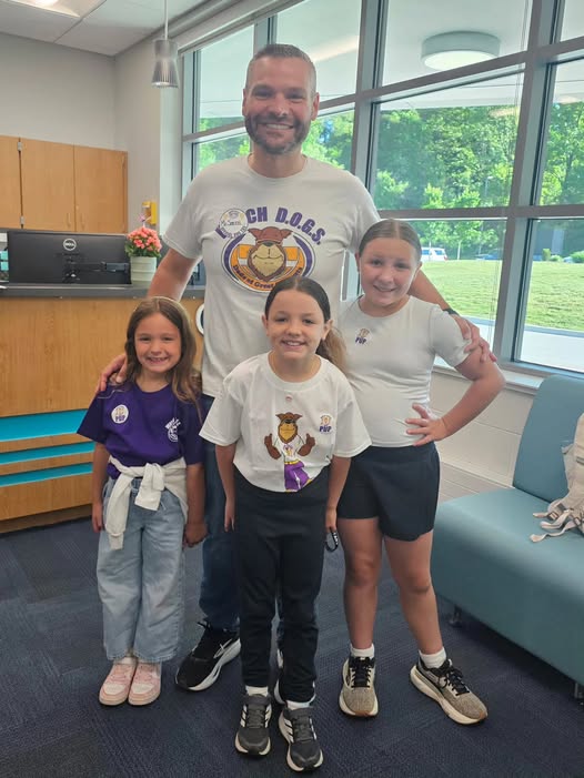 Adult posing with student in school office for the watch d.o.g.s. program