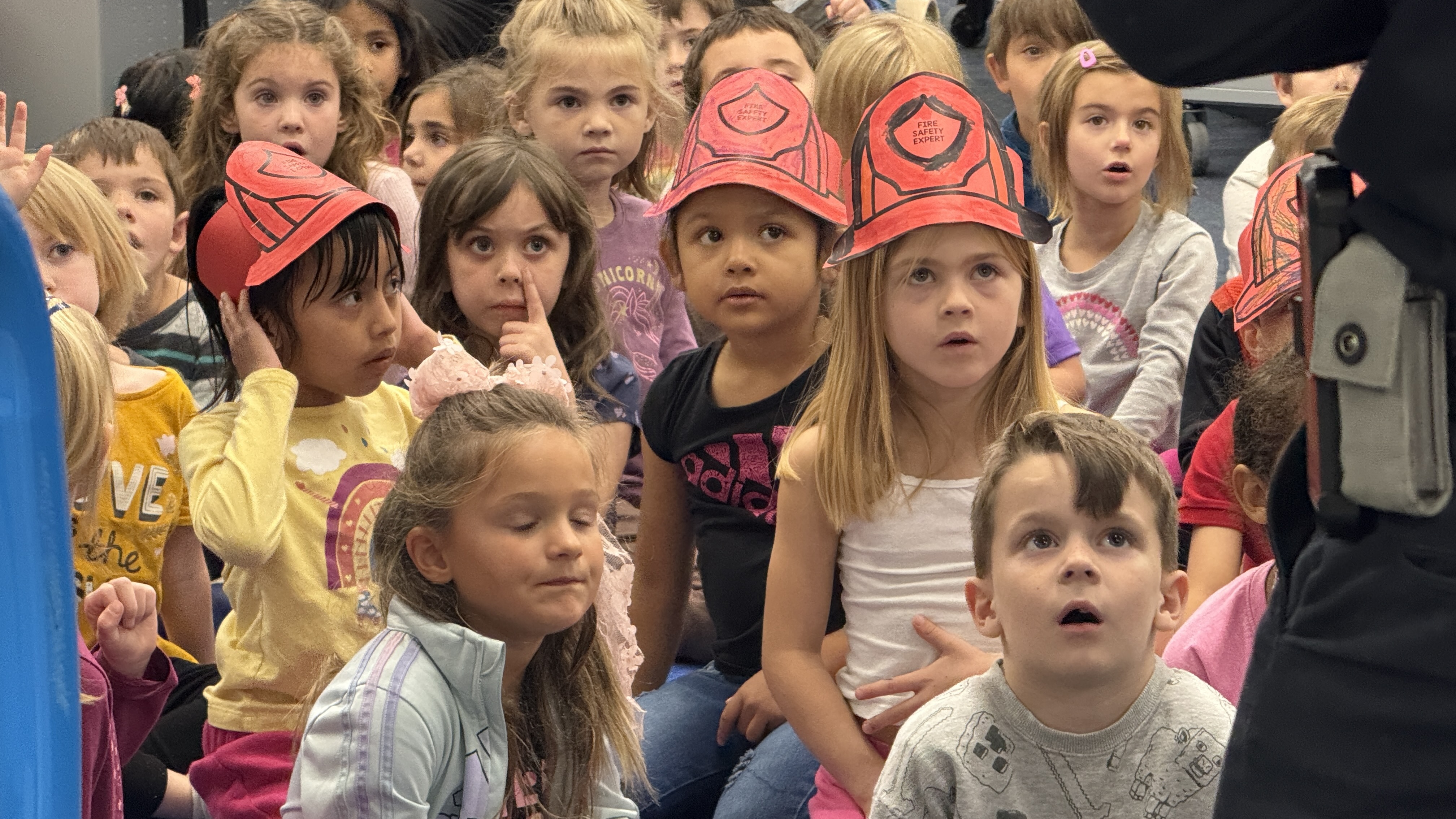 Kids sitting on floor listening 