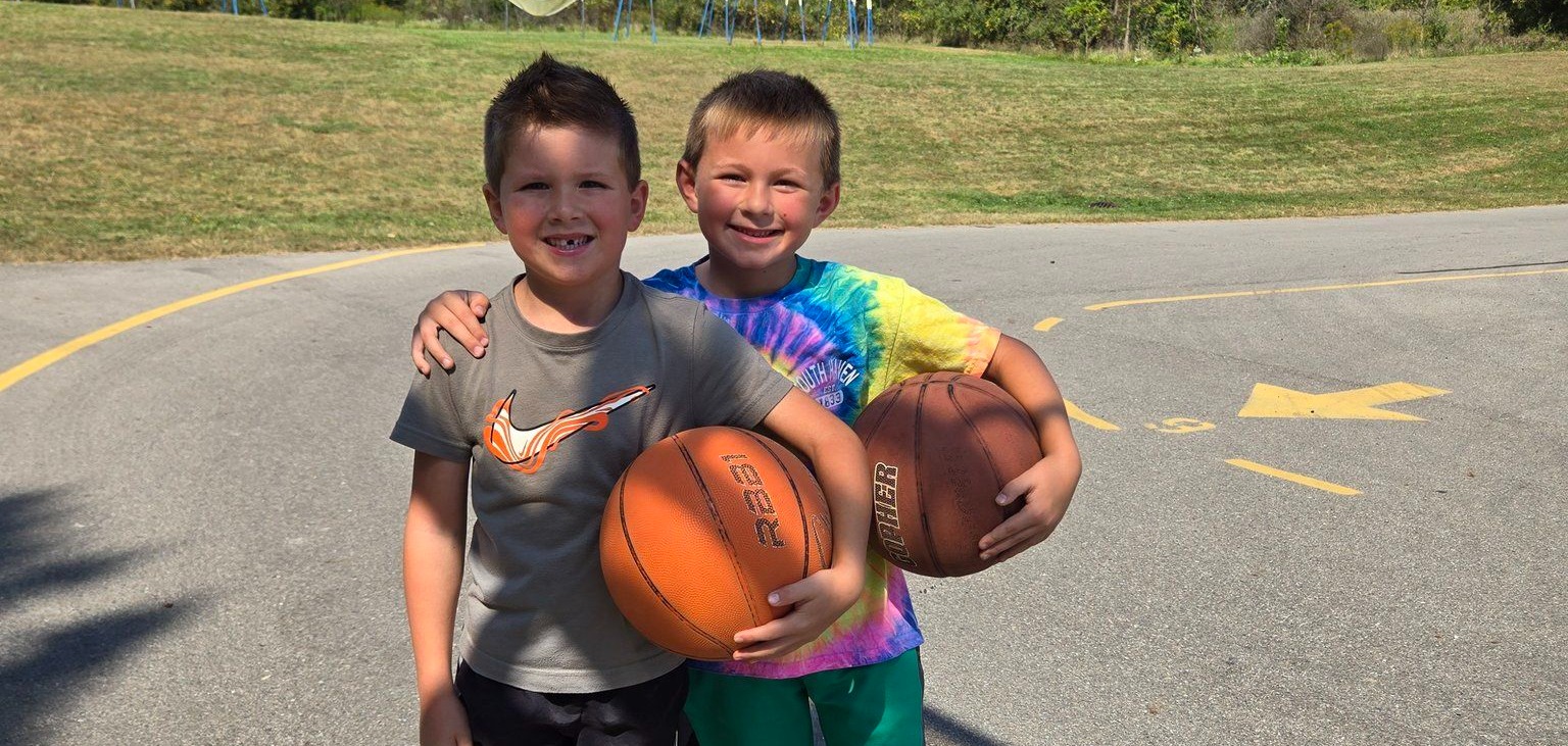 2 students playing basketball