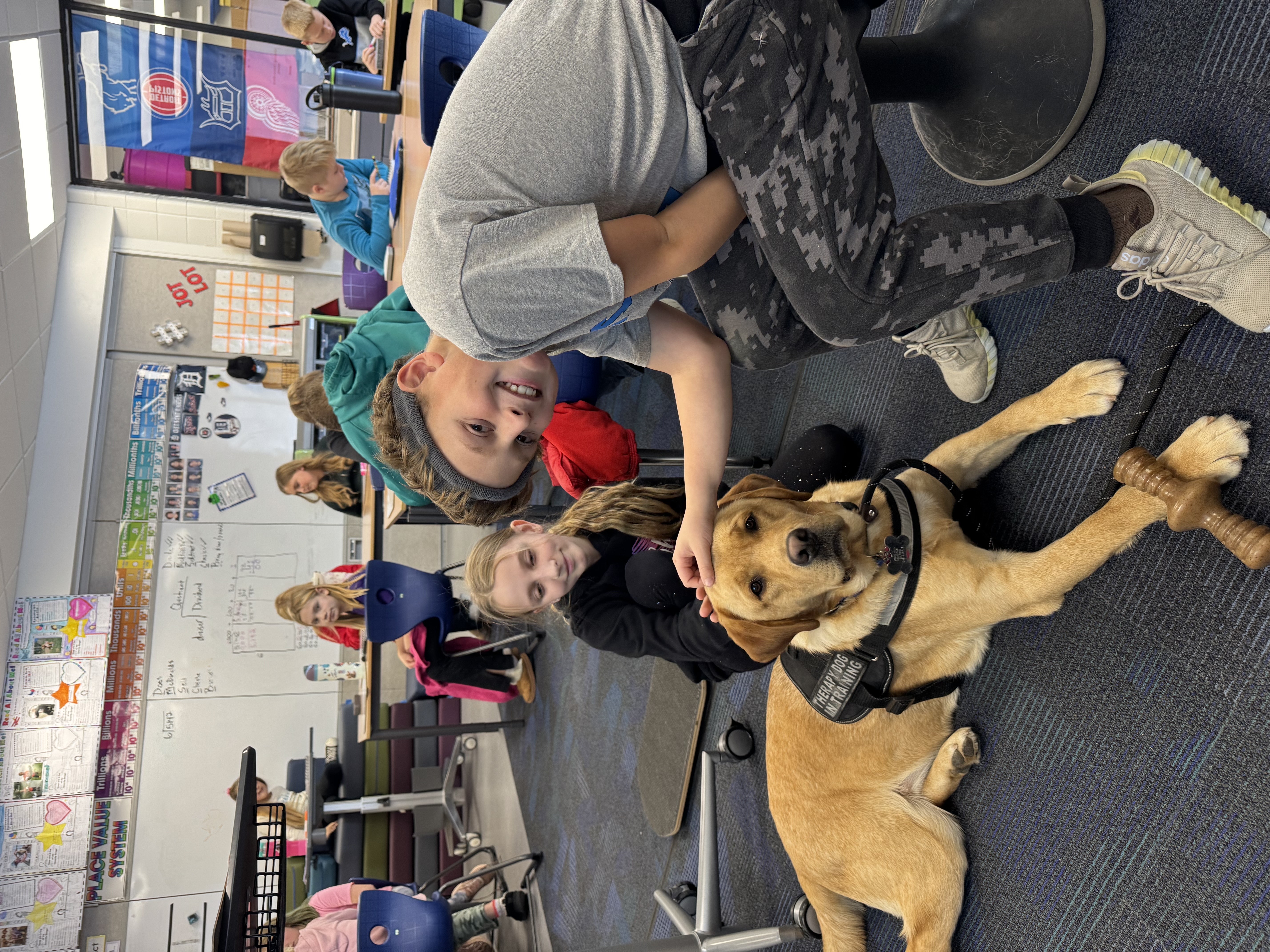 Image of students petting therapy dog