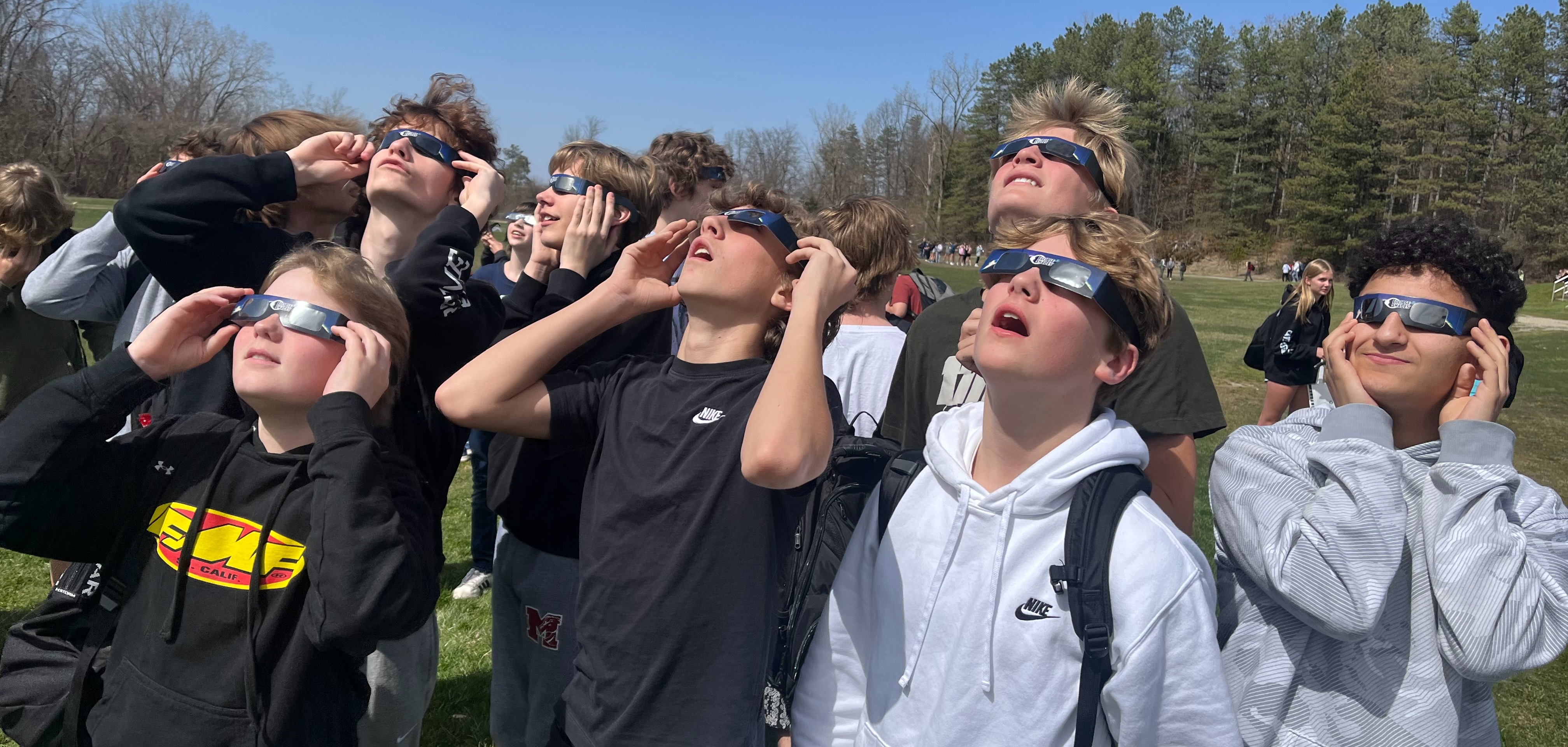 Students enjoying the eclipse with sun protection