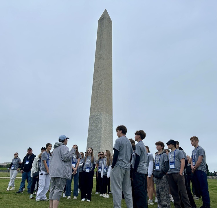 students pose for photo at monument in DC