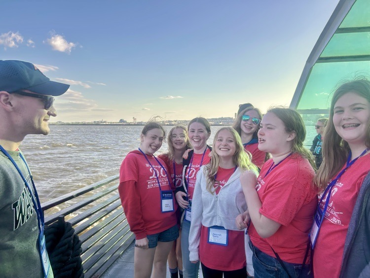 students pose for photo at monument in DC