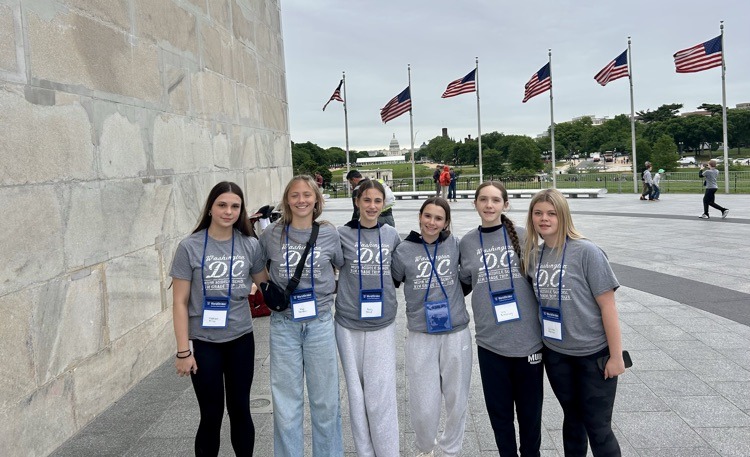 students pose for photo at monument in DC