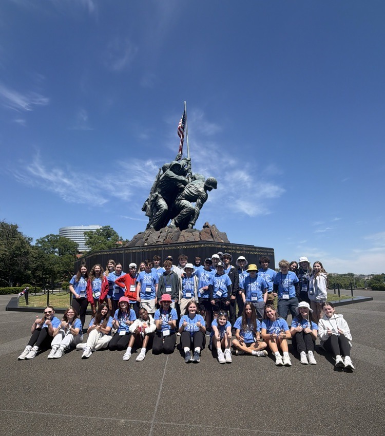 students pose for photo at monument in DC