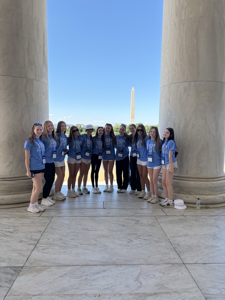students pose for photo at monument in DC