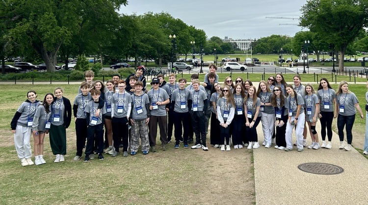 students pose for photo at monument in DC