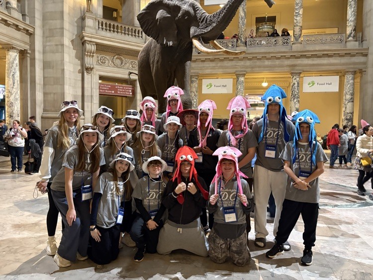 students pose for photo at monument in DC