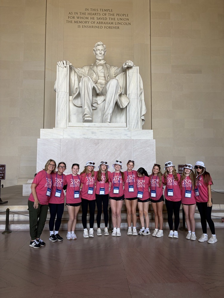 students pose for photo at monument in DC