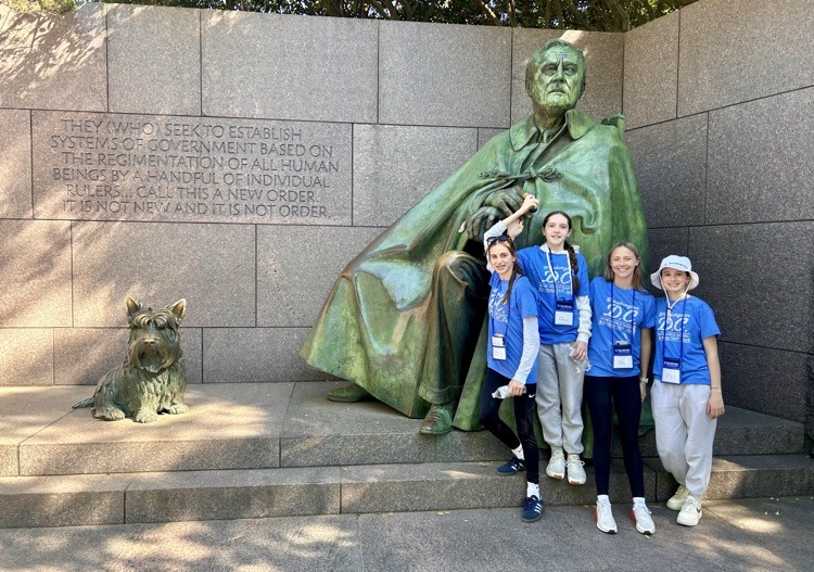 students pose for photo at monument in DC