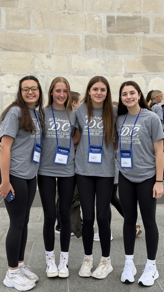 students pose for photo at monument in DC