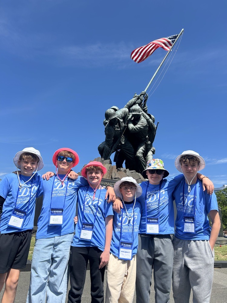 students pose for photo at monument in DC