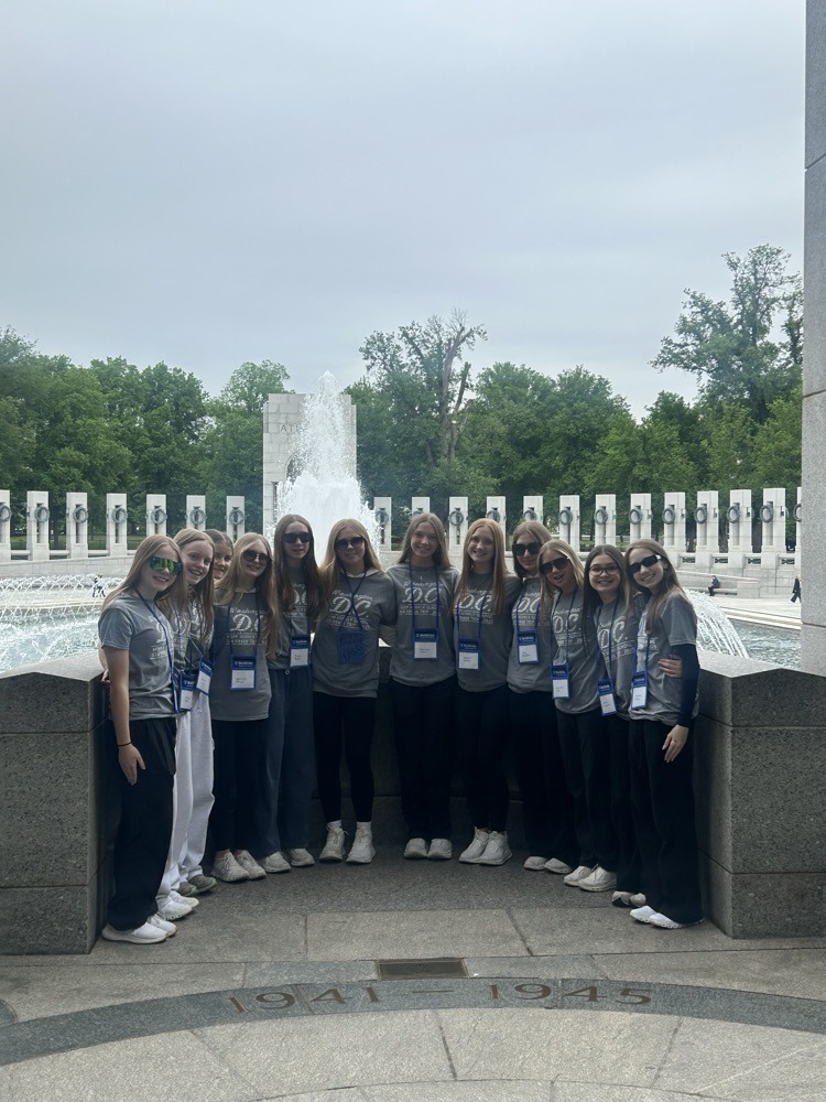 students pose for photo at monument in DC