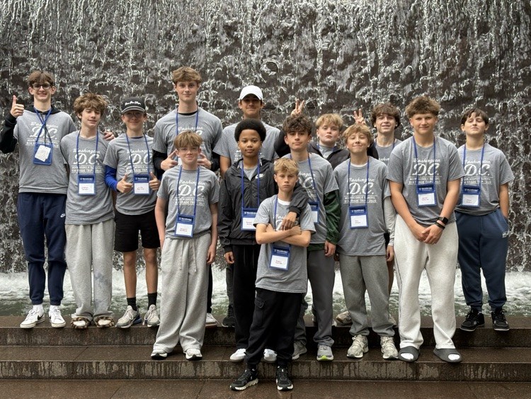 students pose for photo at monument in DC