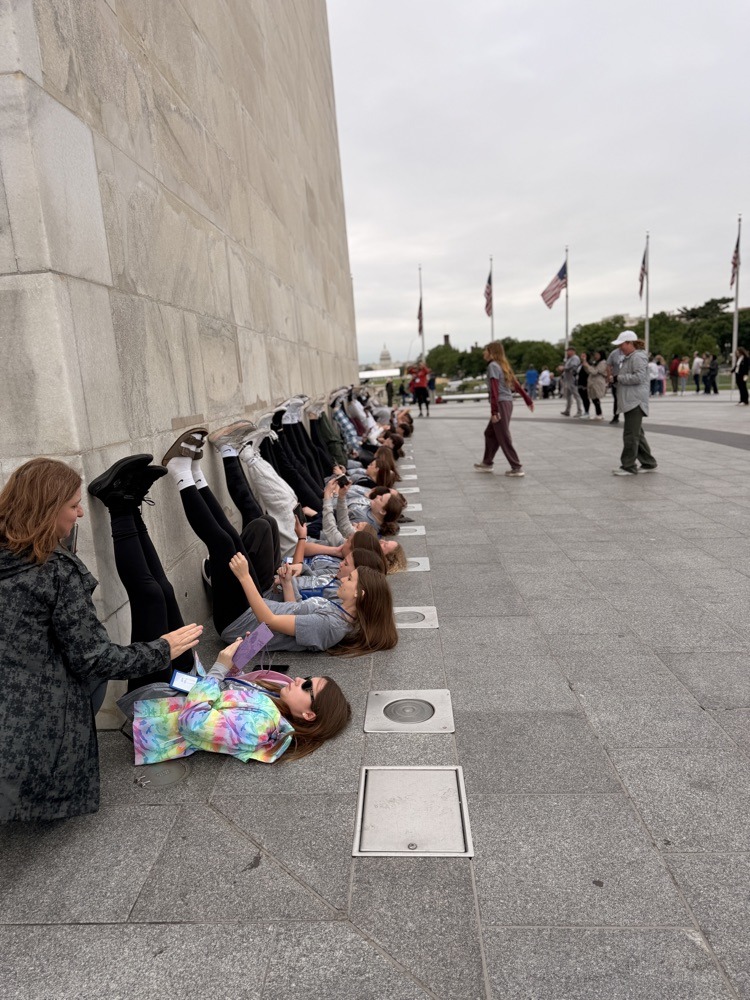students pose for photo at monument in DC