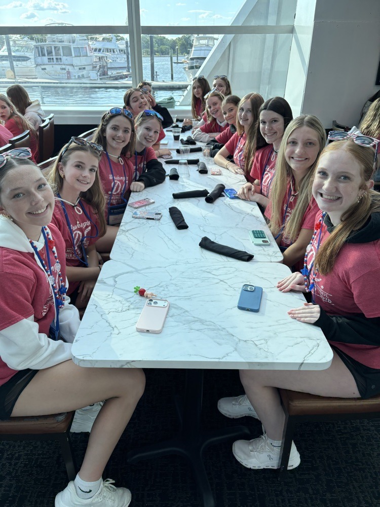 students pose for photo at restaurant