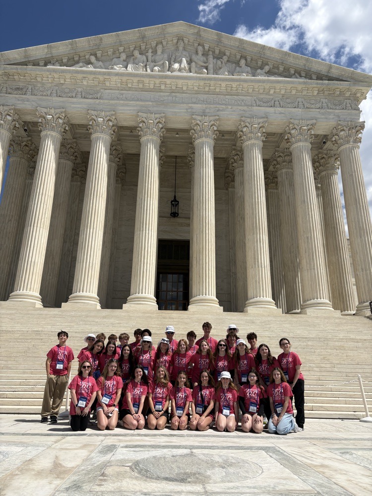 students pose for photo at monument in DC