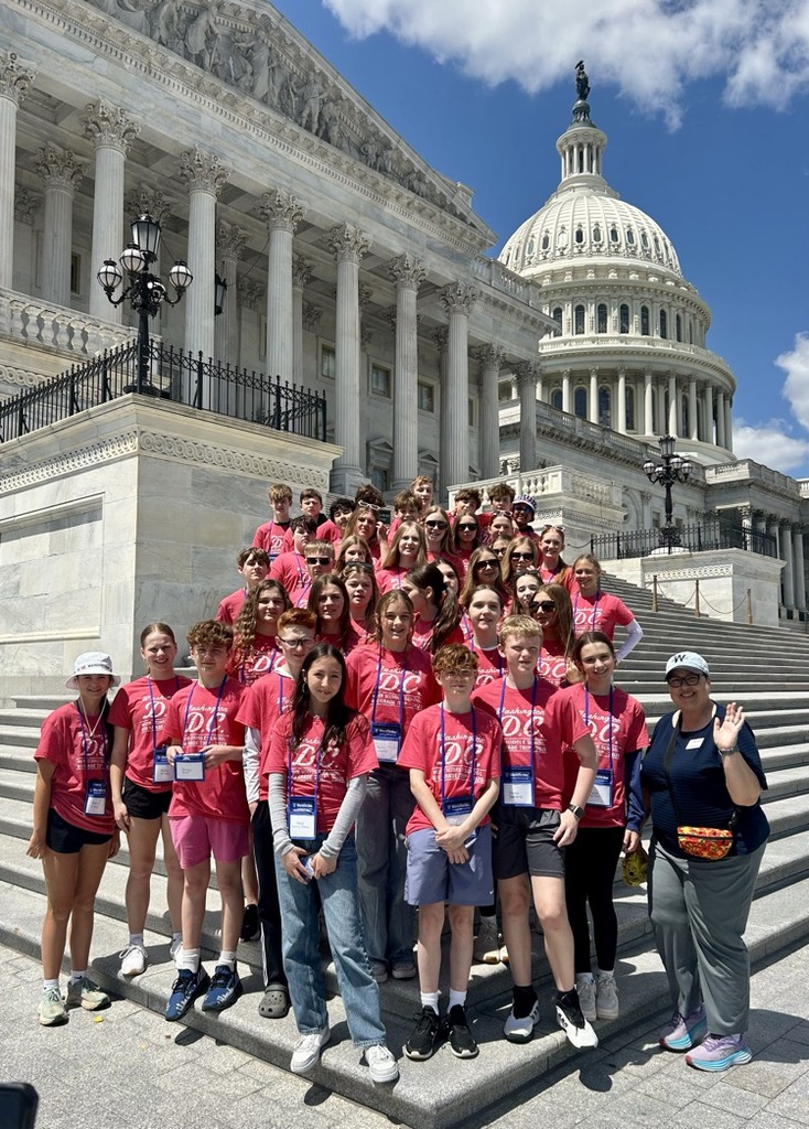 students pose for photo at monument in DC