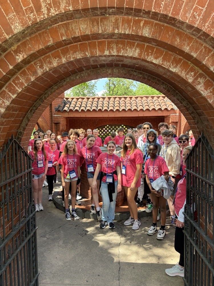 students pose for photo at monument in DC