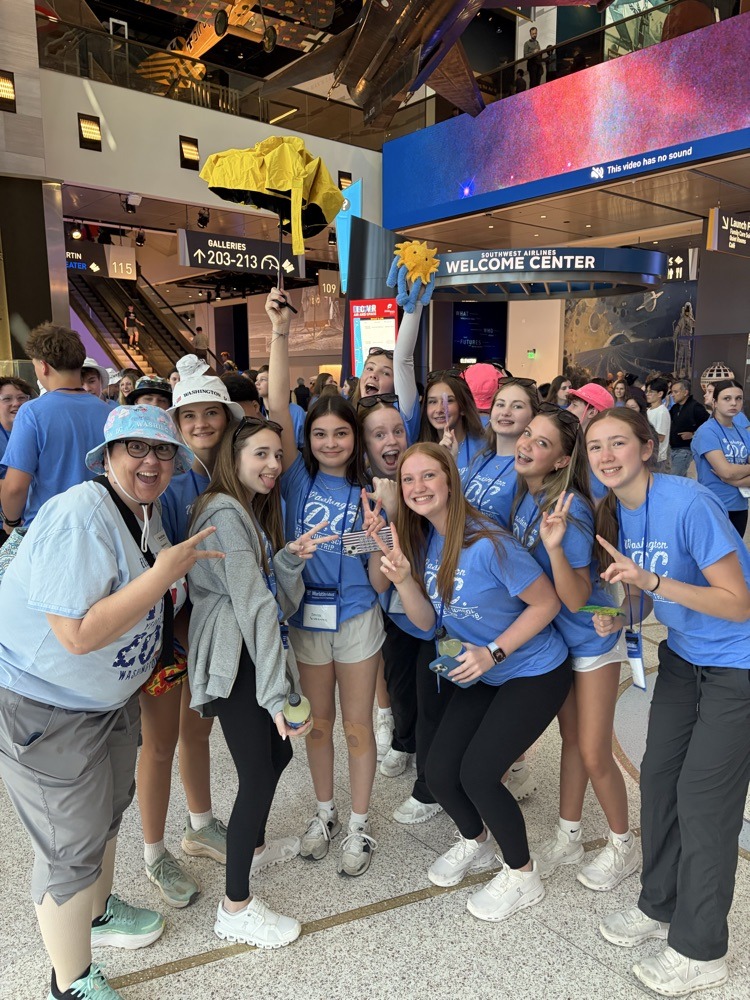 students pose for photo at monument in DC