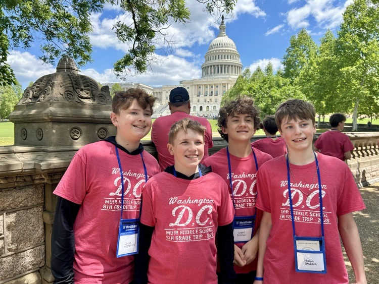 students pose for photo at monument in DC